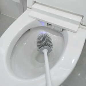Cepillo de silicón para inodoro con mango largo y base.